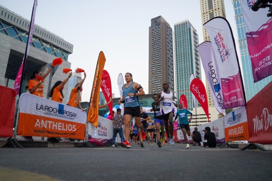 City marathon runners surge towards the finish line, capturing the energy and determination of the event.